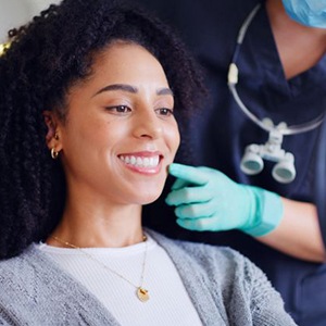 Cosmetic dentistry patient looking at her smile in mirror