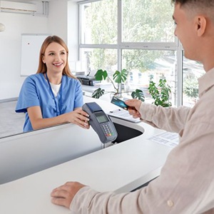 Man providing payment for dental services at front desk