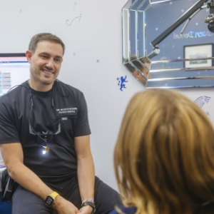 A dentist discussing other payment options with male patient