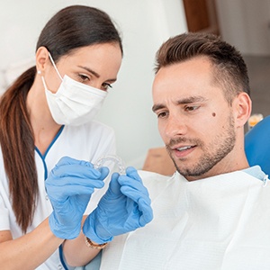 A man visiting his dentist for Invisalign treatment