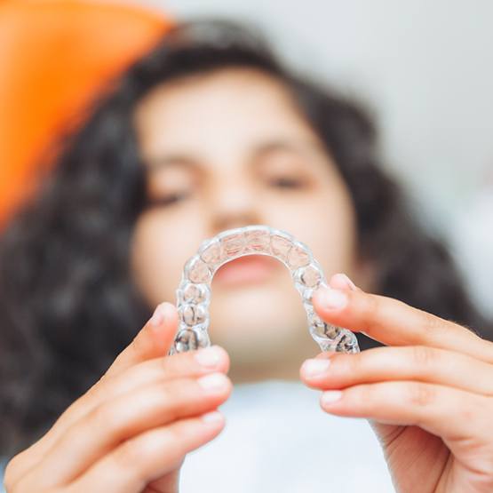 Young woman holding Invisalign