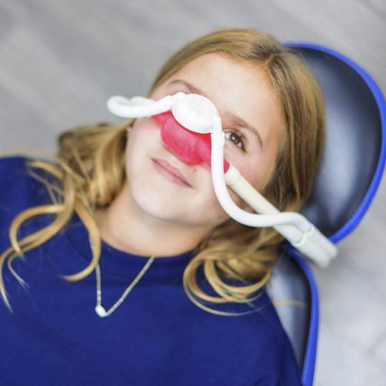 Dental patient with a nitrous oxide mask over his nose