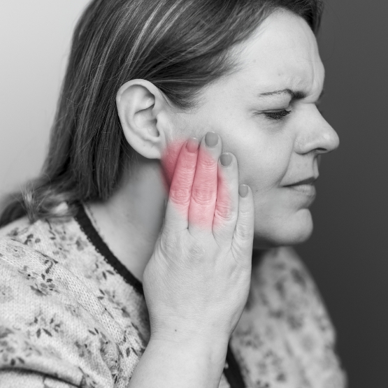 Man holding the side of his face in pain before TMJ treatment in Chicago